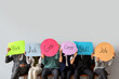 © Pixel-Shot - Business people holding speech bubbles with words on light background
