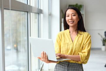 Sticker - Asian businesswoman working with laptop in office