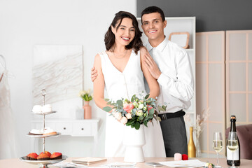 Poster - Young couple with bouquet planning their wedding in office