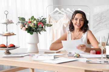 Wall Mural - Young woman planning her wedding in office