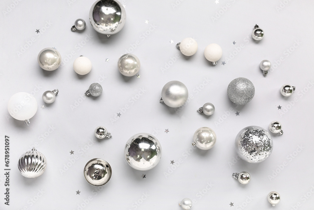 Silver Christmas balls with confetti on white background
