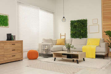 Sticker - Green artificial plant wall panel and comfortable furniture in cozy living room. Interior design