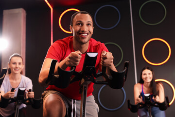 Sticker - Group of people training on exercise bikes in fitness club