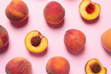 Wall Mural - Cut and whole fresh ripe peaches on pink background, flat lay