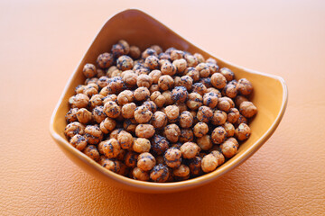 Canvas Print -  toasted chickpeas in a bowl on orange color background 