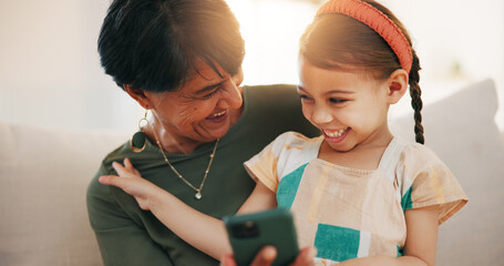 Sticker - Child, grandmother and cellphone laugh on sofa or online connection, games or bonding. Kid, old woman and smile for social media or funny joke embrace on couch together relax, love or trust safety