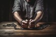 Male hands in handcuffs on wooden table. Iron chains on the hands