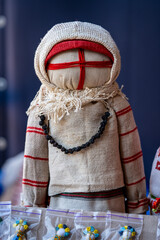 Close-up of a traditional amulet doll for sale to tourists at a street market, Kyiv, Ukraine. Ukrainian motanka dolls