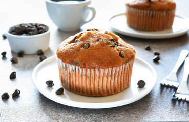 Wall Mural - Muffin with chocolate chips and a cup of coffee. Morning and breakfast time.