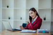 © Witoon - Portrait of a happy beautiful Asian businesswoman.Working with a tablet in a company office