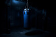 illustration of a blue boxing bag in dark room. Created with Generative AI