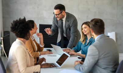 Successful business professionals presenting analytical report, working together in corporate office