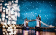 christmas lights and snow in London Tower bridge at night