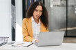 © NINENII - Businesswomen hand working with tablet and laptop computer with documents on office desk in modern office.