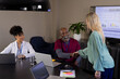© Wavebreak Media - Happy diverse male and female medical staff shaking hands at office meeting