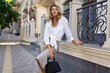 © Svetlana Sokolova - Outdoor portrait of beautiful  blond woman  perfect wavy hairs  holding luxury hand bag. Fashion acsessories , Casual outfit.