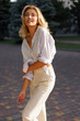 © Svetlana Sokolova - Beautiful blond woman  in stylish fashion casual outfit posing  on the street.  Warm sunset color.