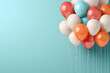 Сolored helium balloons on a festive turquoise background with place for text
