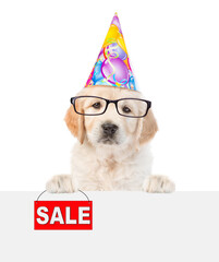 Poster - Funny Golden retriever puppy wearing eyeglasses and party cap shows signboard with labeled 