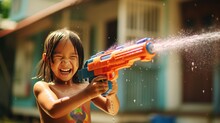 Children Use Water Guns To Play Songkran In Summer