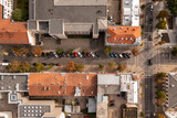 Fototapeta Miasto - Drone photography of city center streets, houses, rooftops and full parking places