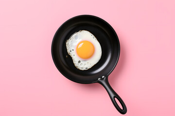 Wall Mural - Fried egg on pan isolated on pink background