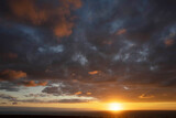 Fototapeta Sypialnia - Photo shot of dark clouds during sunset