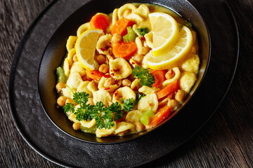 Canvas Print - orecchiette pasta chickpea soup in black bowl