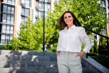 Wall Mural - Photo of cheerful stunning shiny lady wear trendy white shirt buy modern flat residential complex outdoors