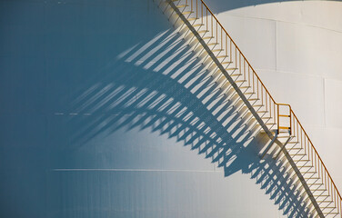 Wall Mural - Detail of white tanks oil in tank farm with iron shadow