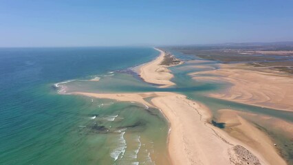 Canvas Print - Aerial video filming by drone of the marine reserve Ria Formosa Faro Portugal Algarve. Praia de Barrinha. Flight over the coastal spit between the park and the ocean with a view of the canal.