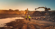 © Gorodenkoff - Aerial Drone Shot Of Construction Site With Excavators On Sunny Day: Diverse Team of Real Estate Developers Discussing Project. Engineer, Architect, Investor Talking About New Building, Using Tablet.