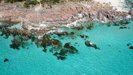 Sticker - Tranquil beach with pristine sand and a calm turquoise-colored sea in the background