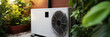 Outdoor unit of air source heat pump near the house, heating and cooling the house, banner