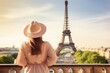 © Iftikhar alam - Young woman in hat with Eiffel Tower in background, Paris, France, Rear view of woman tourist in sun hat standing in front of Eiffel Tower in Paris. Travel in France, tourism concept, AI Generated