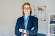 © okrasiuk - Portrait of smiling 50's stylish, confident mature businesswoman, middle aged company ceo director, experienced senior female professional, business coach team leader in modern office. Female leader