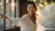© anandart - Happy smiling middle aged woman in calm environment, doing stretching, yoga or tai chi exercises, physical and mental health concept, wellness indoors, space for text