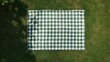 © HN Works - top view of picnic blanket on ground, advertising concepts, copy space. linen tablecloth or white textile plaid on green lawn in garden outdoor at summer day, flat lay
