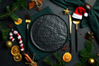 Festive Christmas table setting. A plate with festive cutlery on the table. Free copy space. Top view On a dark background.