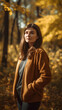 © tynza - Young beautiful woman with long dark hair standing thoughtfully in the autumn park on yellow trees background