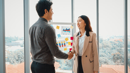 Business people handshake in corporate office showing professional agreement on a financial deal contract. Jivy