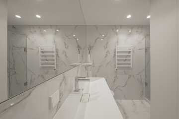 Wall Mural - Modern minimalist white bathroom interior design with marble style tiles and white taps, vase and wall heater