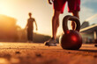 man lifting kettlebell on the ground in a workout