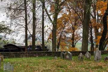 Sticker - View of a Steam Engine Passing an Old Cemetery, Blowing Smoke on an Autumn day
