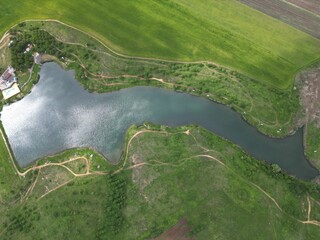 Wall Mural - an aerial photo of a large lake and lush greenery