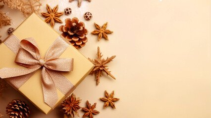 Wall Mural - Beautiful golden festive gift box and pine cones on a cream background Christmas and new year celebration greeting card desktop wallpaper