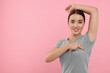 © New Africa - Beautiful young woman doing breast self-examination on pink background, space for text