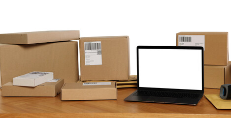 Poster - Different parcels and laptop on wooden table against white background. Online store