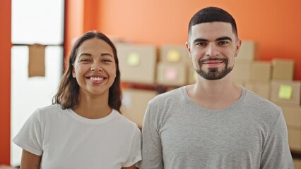 Sticker - Two smiling workers, a man and woman standing together, brimming with confidence at their office, packaging e-commerce deliveries