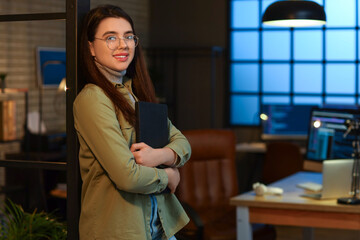 Wall Mural - Young female programmer with laptop in office